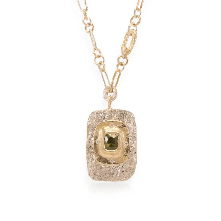Front view of the Square Fragmented Pendant by Alexis Pavlantos, featuring a 1.02-carat Montana sapphire surrounded by recycled diamonds in textured sterling silver and 14k yellow gold.