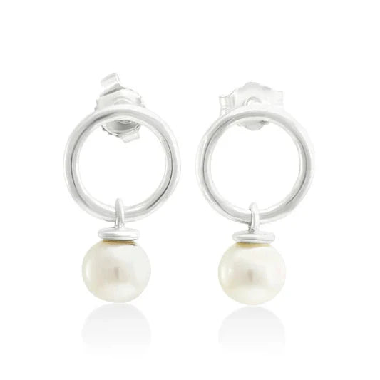 Michaela Farkasovska sterling silver circle stud earrings with dangling white freshwater pearls and minimalist design.