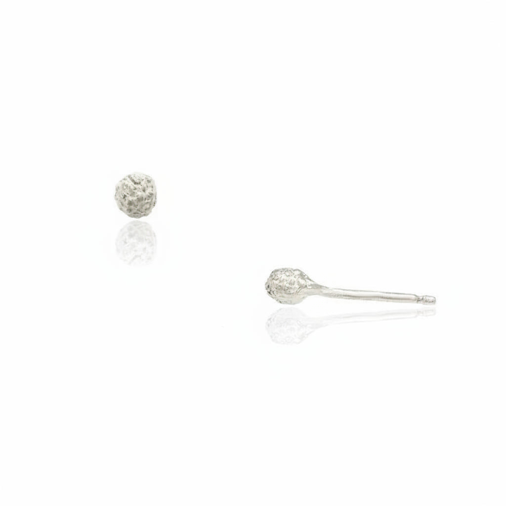 Front and side views of handcrafted sterling silver Stigma Stud Earrings, featuring a delicate 4mm flower-inspired design with textured surfaces and friction post backs.