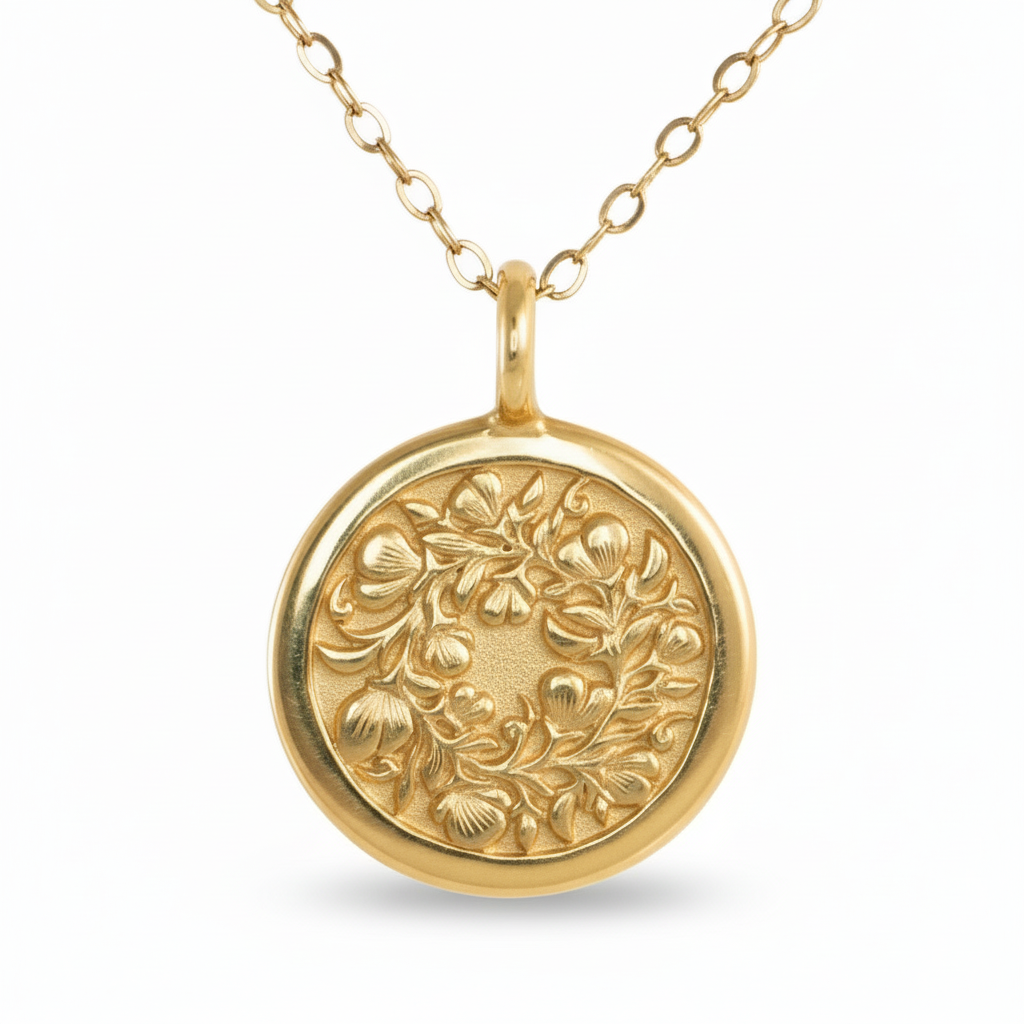 14k gold Sweet Pea pendant on white background – hand-engraved floral motif.