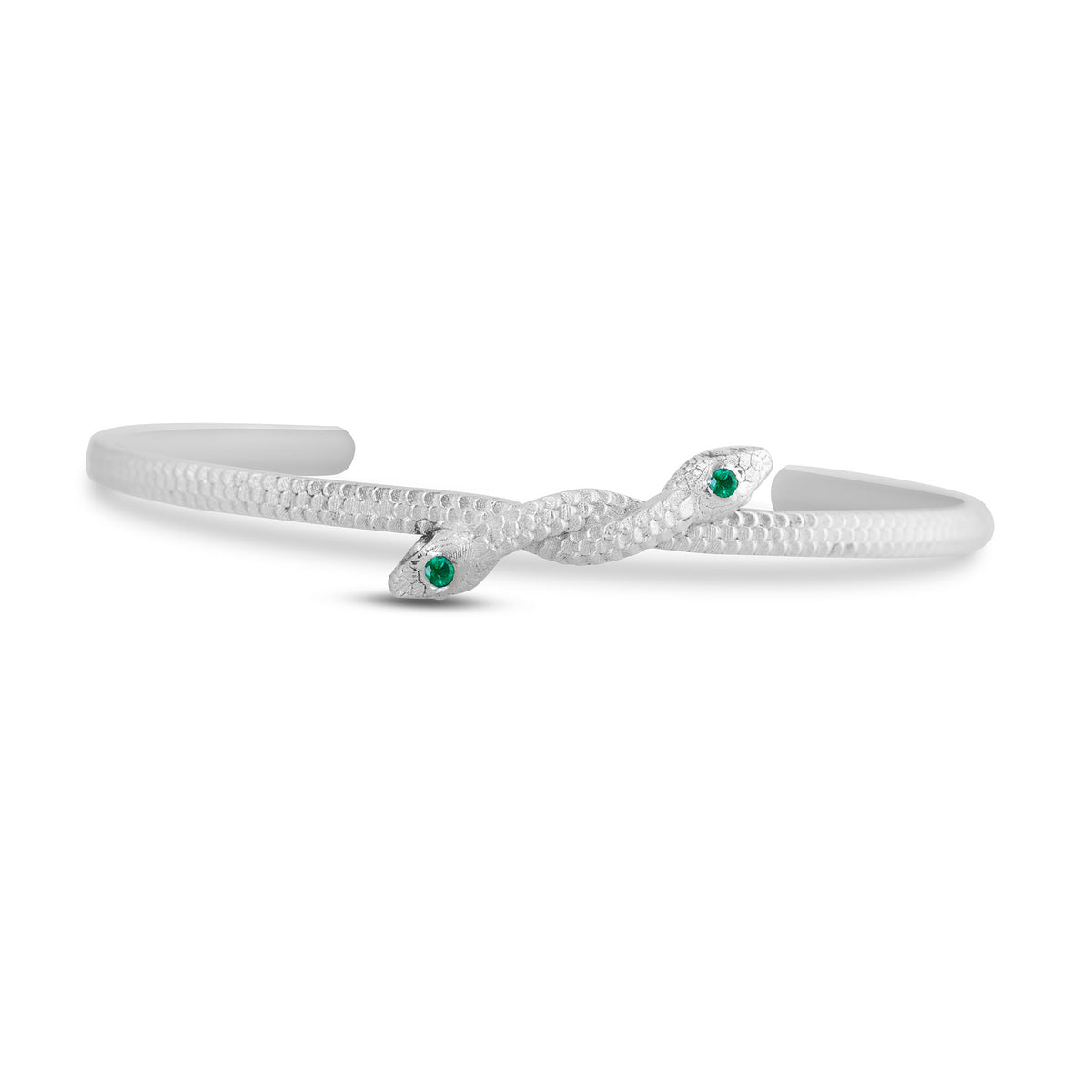 Symbiosis Cuff by Michaela Farkasovska featuring two sculptural sterling silver snakes meeting at the center, each accented with a natural green emerald.