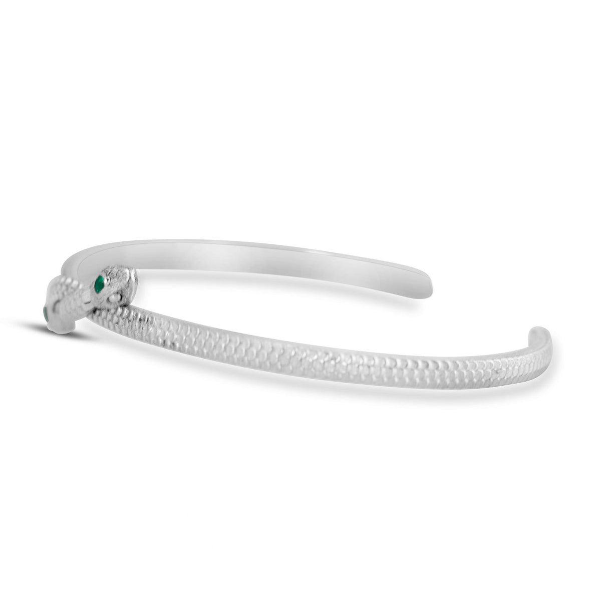 Full view of the Symbiosis Cuff showing its open sterling silver bracelet design with two opposing snake heads and emerald details.