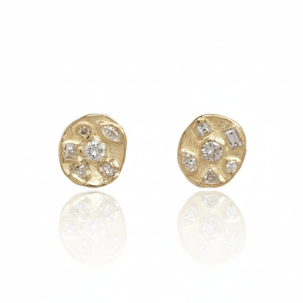 Front view of the Symplegma Diamond Stud Earrings by Alexis Pavlantos, featuring organic 14k yellow gold settings with clusters of white diamonds in assorted shapes and sizes.