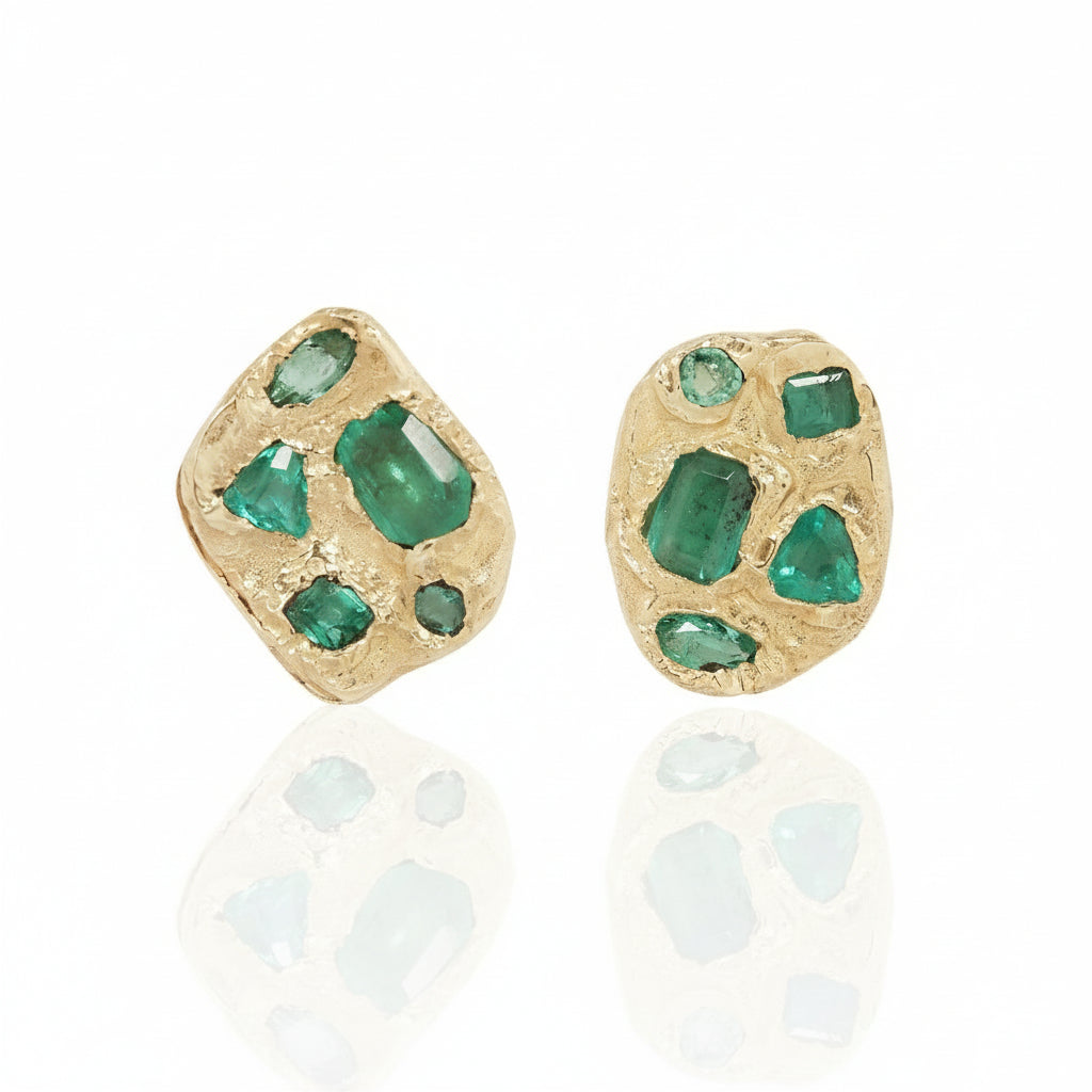 Front view of the Symplegma Emerald Stud Earrings by Alexis Pavlantos, featuring asymmetrical clusters of natural emeralds set in sculptural solid 14k yellow gold.