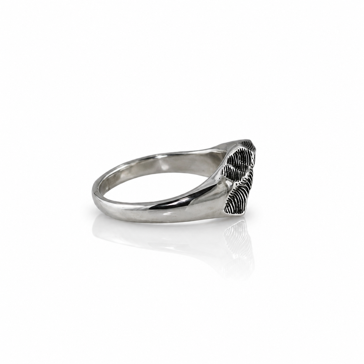 Side view of the Taos Ski Valley Hug Ring showing its curved sterling silver band and textured topographic mountain relief.