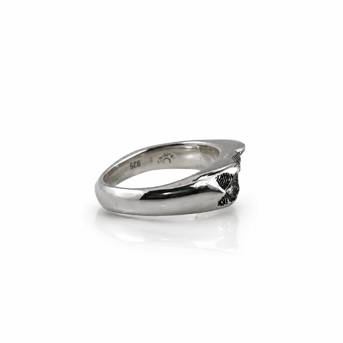 Side view of the Taos Ski Valley Topographic Band showing its polished sterling silver surface and raised mountain contours.