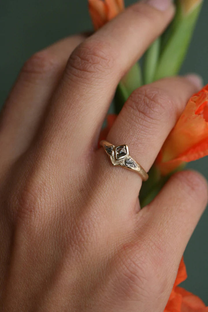 Tava Ring worn on a model's finger, highlighting its sculptural 14k gold design, natural kite-shaped diamond, and delicate proportions.