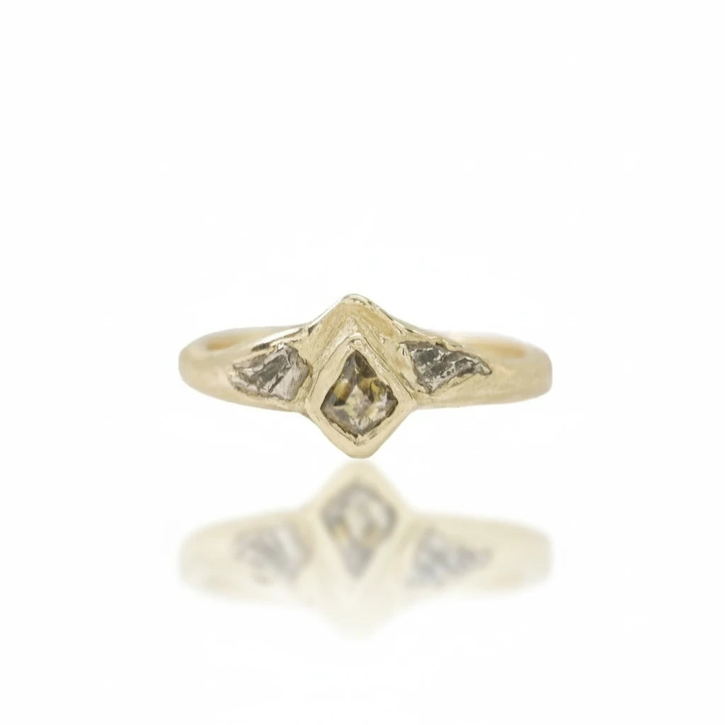 Front view of the Tava Ring by Alexis Pavlantos, featuring a natural kite-shaped diamond set in a sculptural 14k yellow gold band inspired by Colorado rock formations.