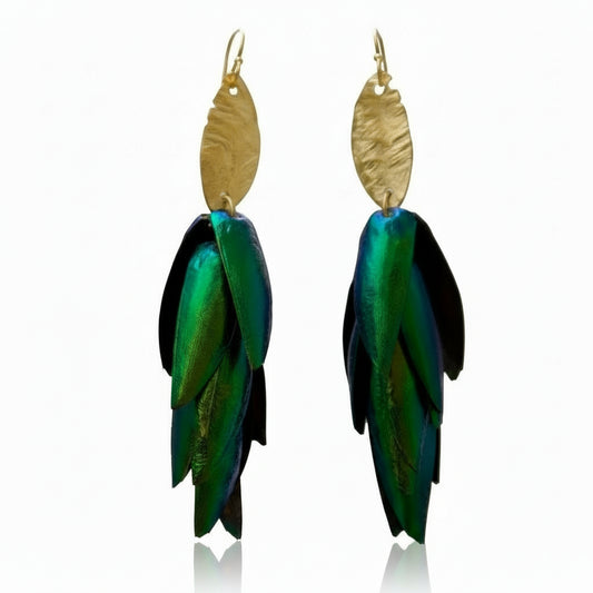 The Body That Remains earrings by Lingua Nigra, featuring iridescent green beetle wings suspended from sculptural 22k gold-plated brass with sterling silver posts.