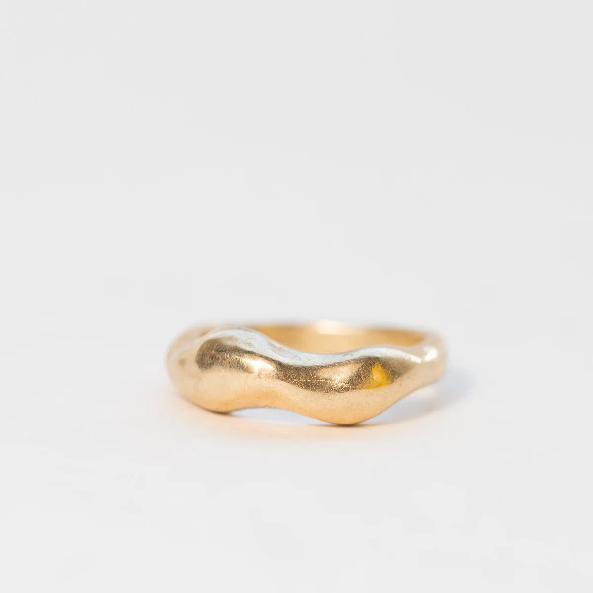 Side view of the Tides Ring in 14k gold vermeil with sculptural wave form.