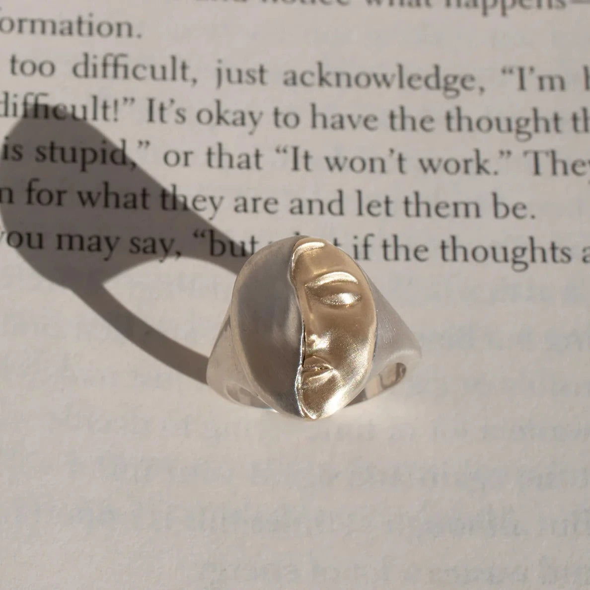 Artistic photograph featuring the Truth Mixed Metal Ring by Michaela Farkasovska and its expressive sculptural design.