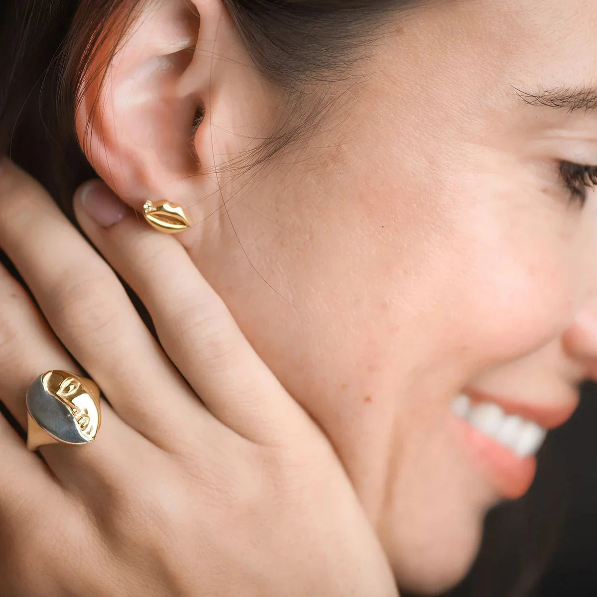 Model wearing the Truth Mixed Metal Ring alongside other handcrafted jewelry, showing its bold sculptural design.