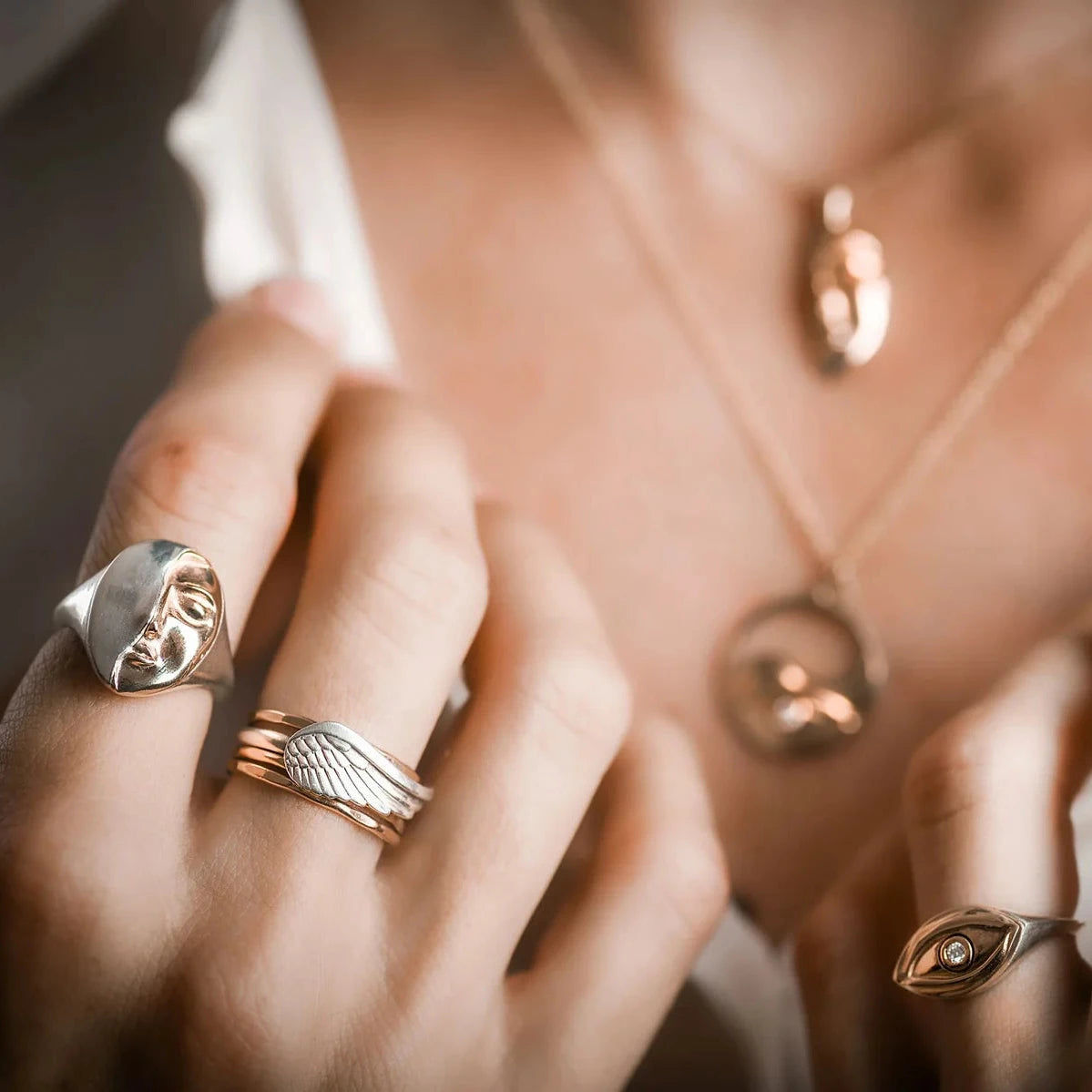 Truth Mixed Metal Ring styled with other statement rings on a hand, highlighting its distinctive gold and silver design.