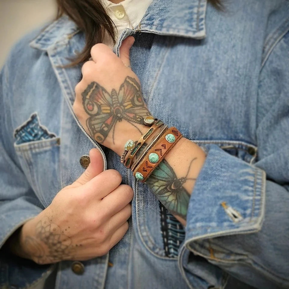Kelly Horrigan turquoise leather cuff bracelet worn on the wrist, showing handcrafted brown leather, natural turquoise stones, and Southwestern-inspired detailing.
