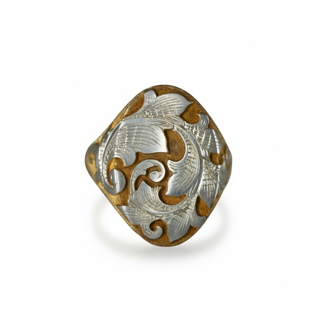 Two-tone acanthus engraved signet ring on white background – detailed silver and gold scroll design
