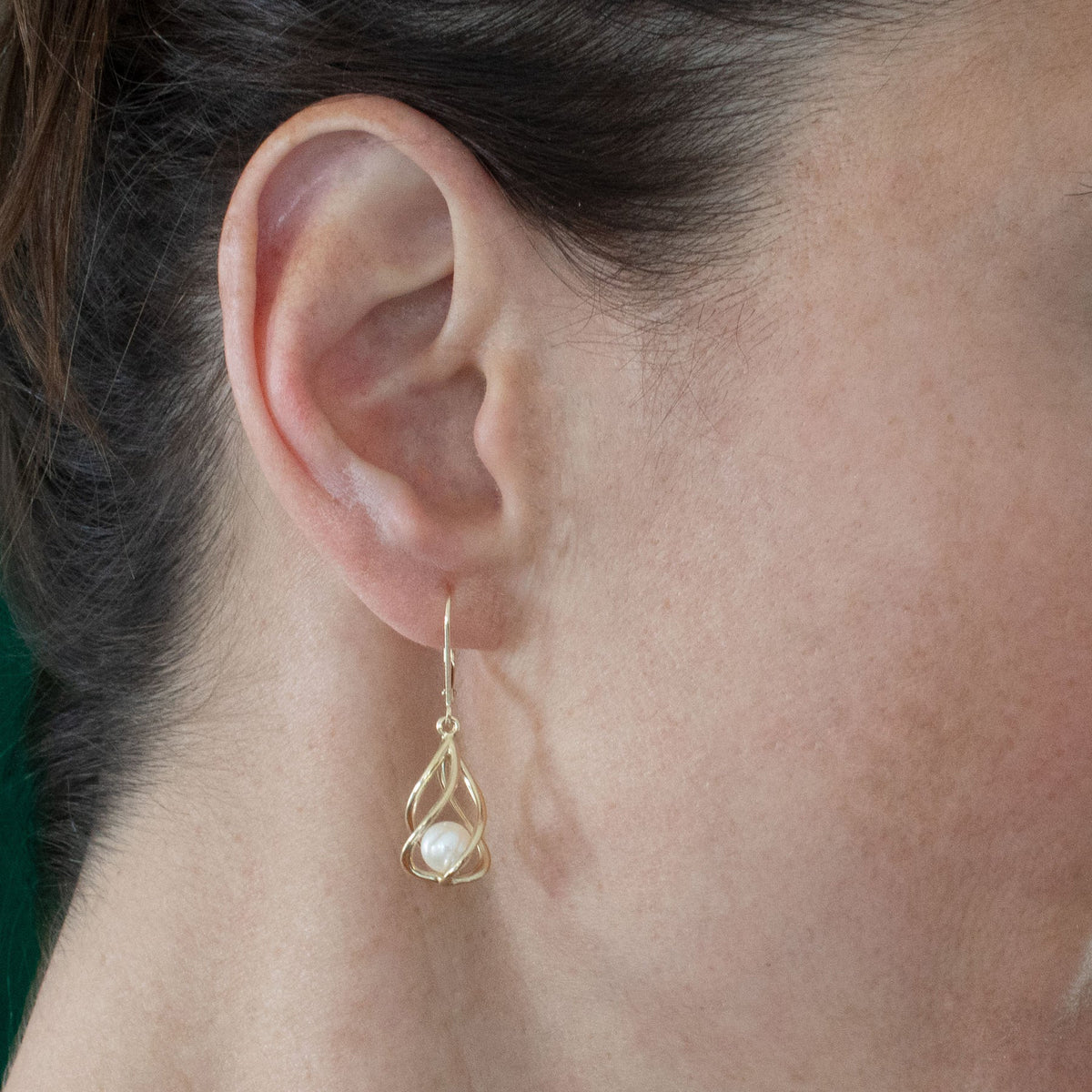 Model wearing sterling silver Vine Earrings with dangling freshwater pearls, showing their delicate length and sculptural design.