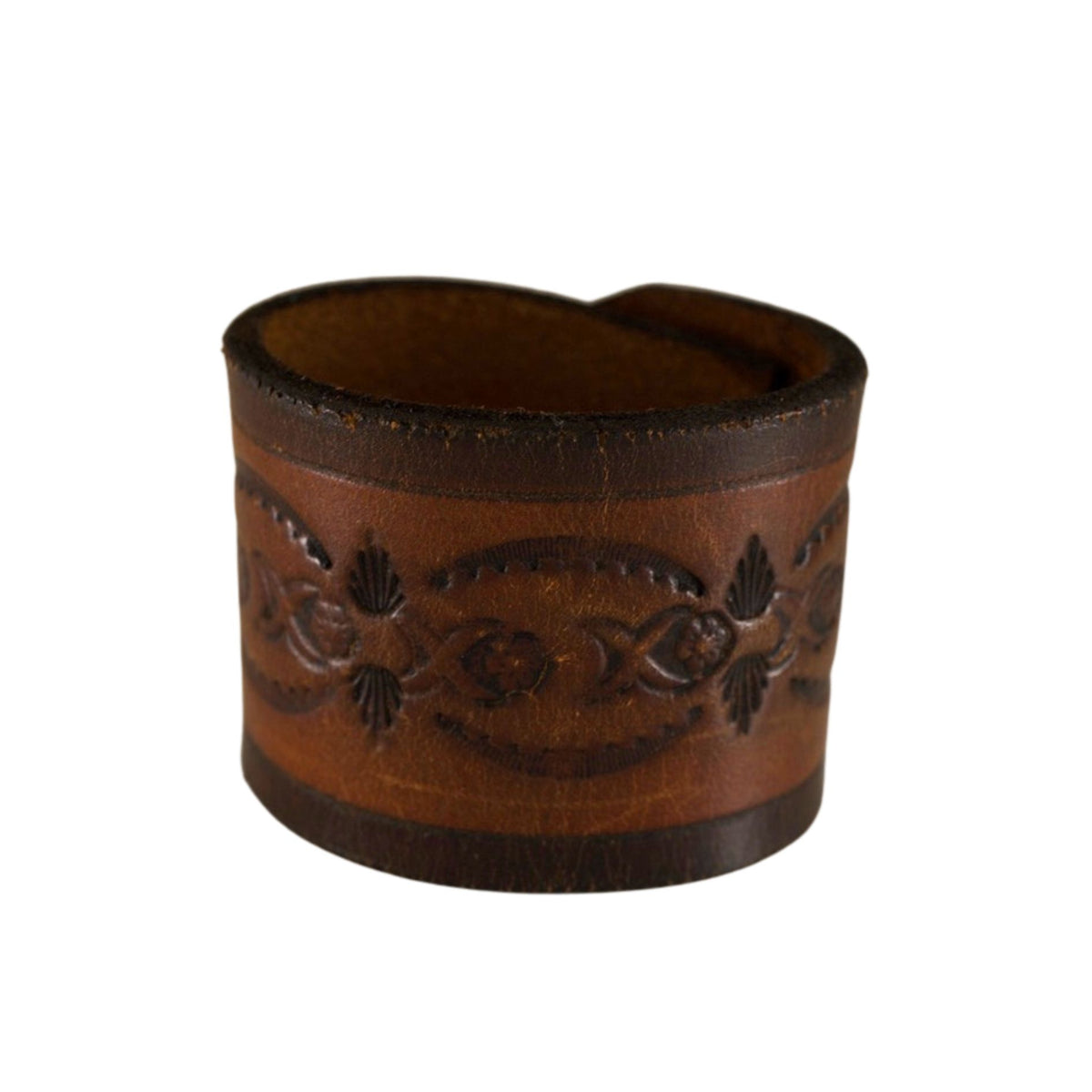 Front view of a handcrafted brown leather cuff bracelet featuring vintage Western tooling and natural patina.