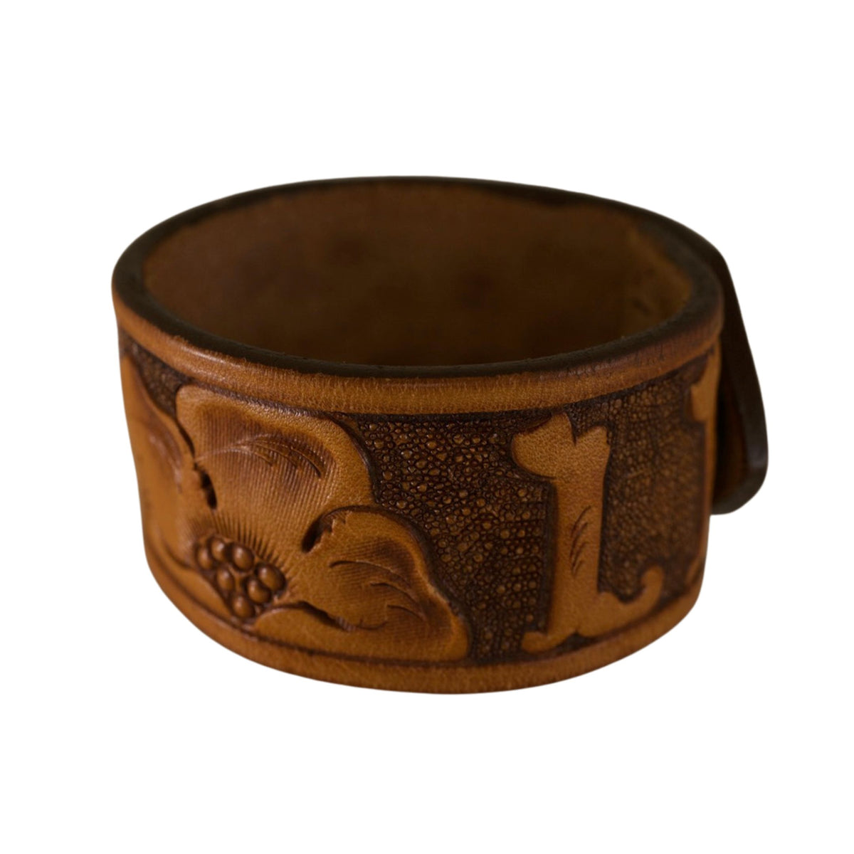 Repurposed brown leather cuff bracelet featuring carved Western motifs and a rustic aged leather finish.