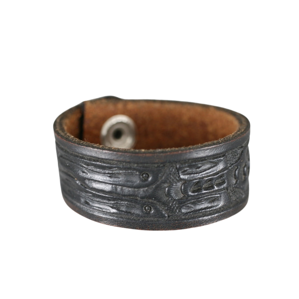 Wide charcoal black leather cuff bracelet with embossed Western patterns and a distressed vintage finish.