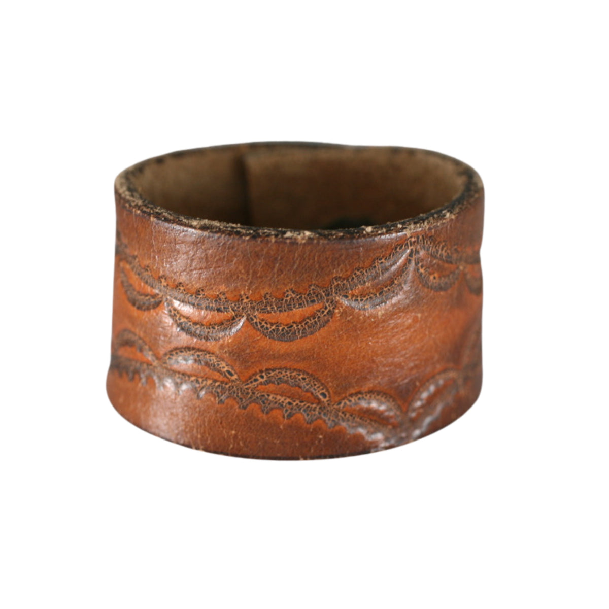 Cognac brown leather cuff bracelet by Kelly Horrigan Handmade, featuring decorative floral tooling and natural leather patina.