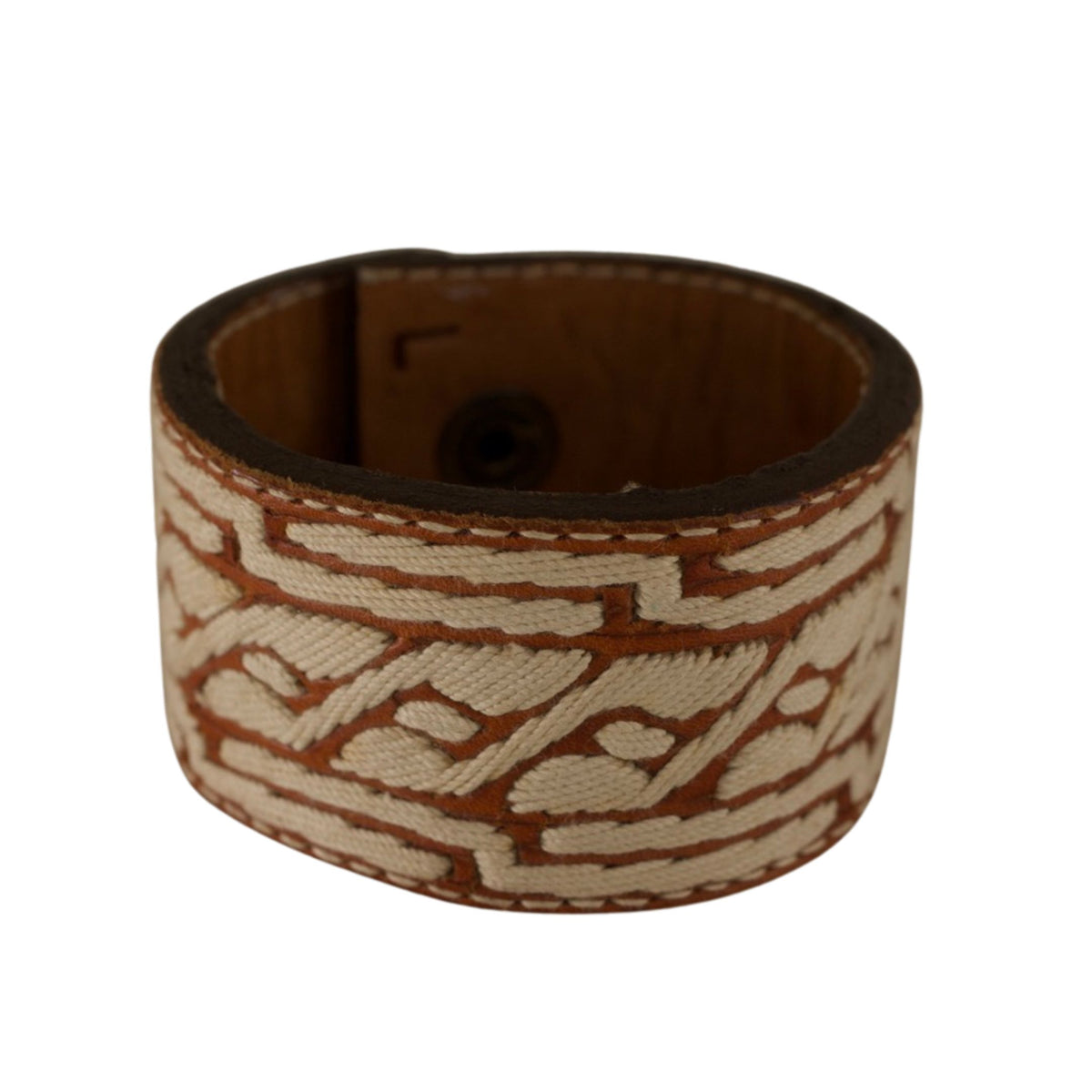 Vintage leather cuff bracelet featuring cream-colored geometric patterns against warm brown repurposed leather.