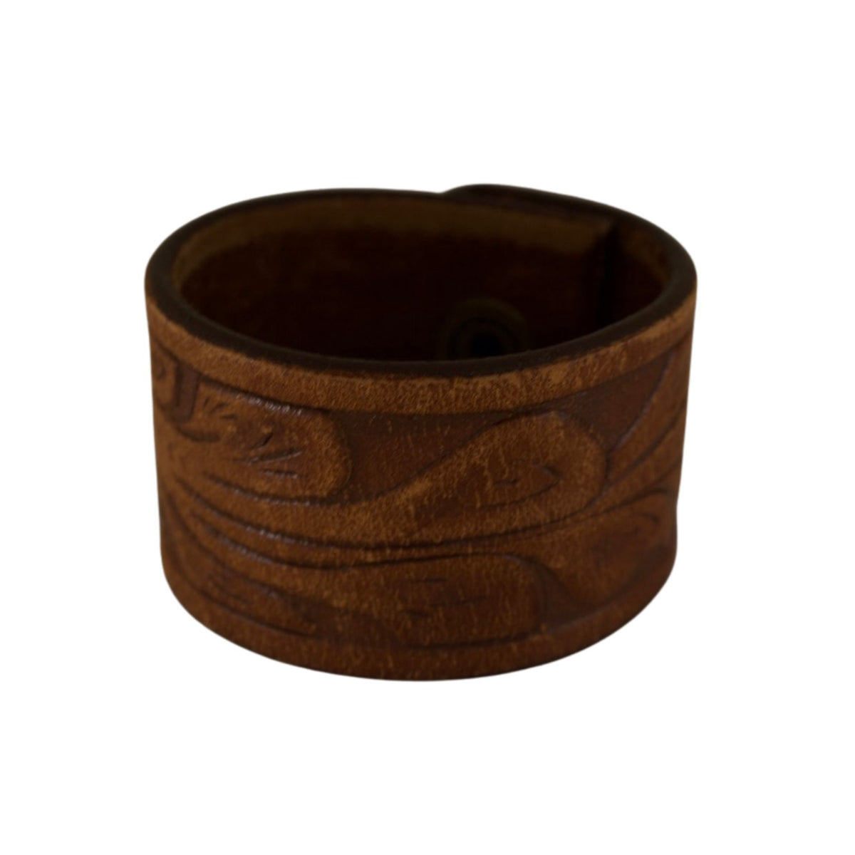 Vintage dark brown leather cuff bracelet with embossed decorative patterns and a rich, naturally worn patina.