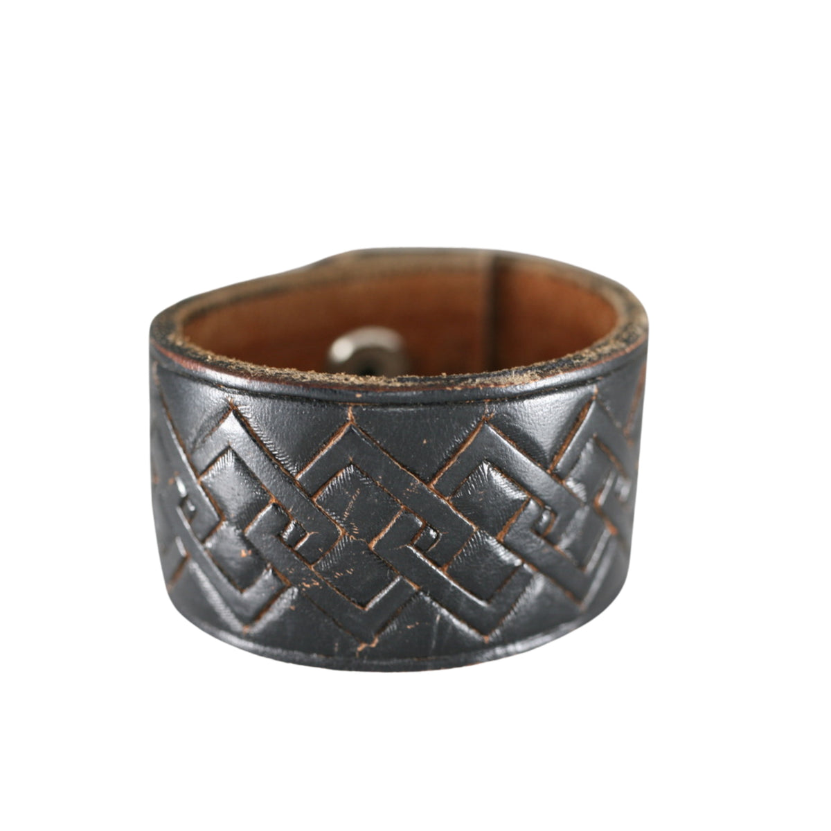 Dark brown repurposed leather cuff bracelet featuring embossed geometric patterns and vintage Western craftsmanship.