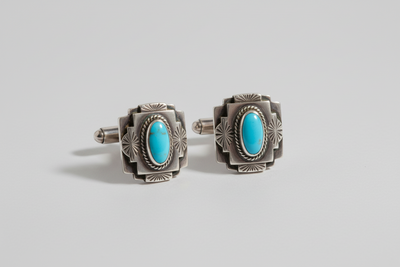 vintage sterling silver art deco Southwest cufflinks laying on a completely solid white background, with shadowing underneath the cufflinks to give depth to the image