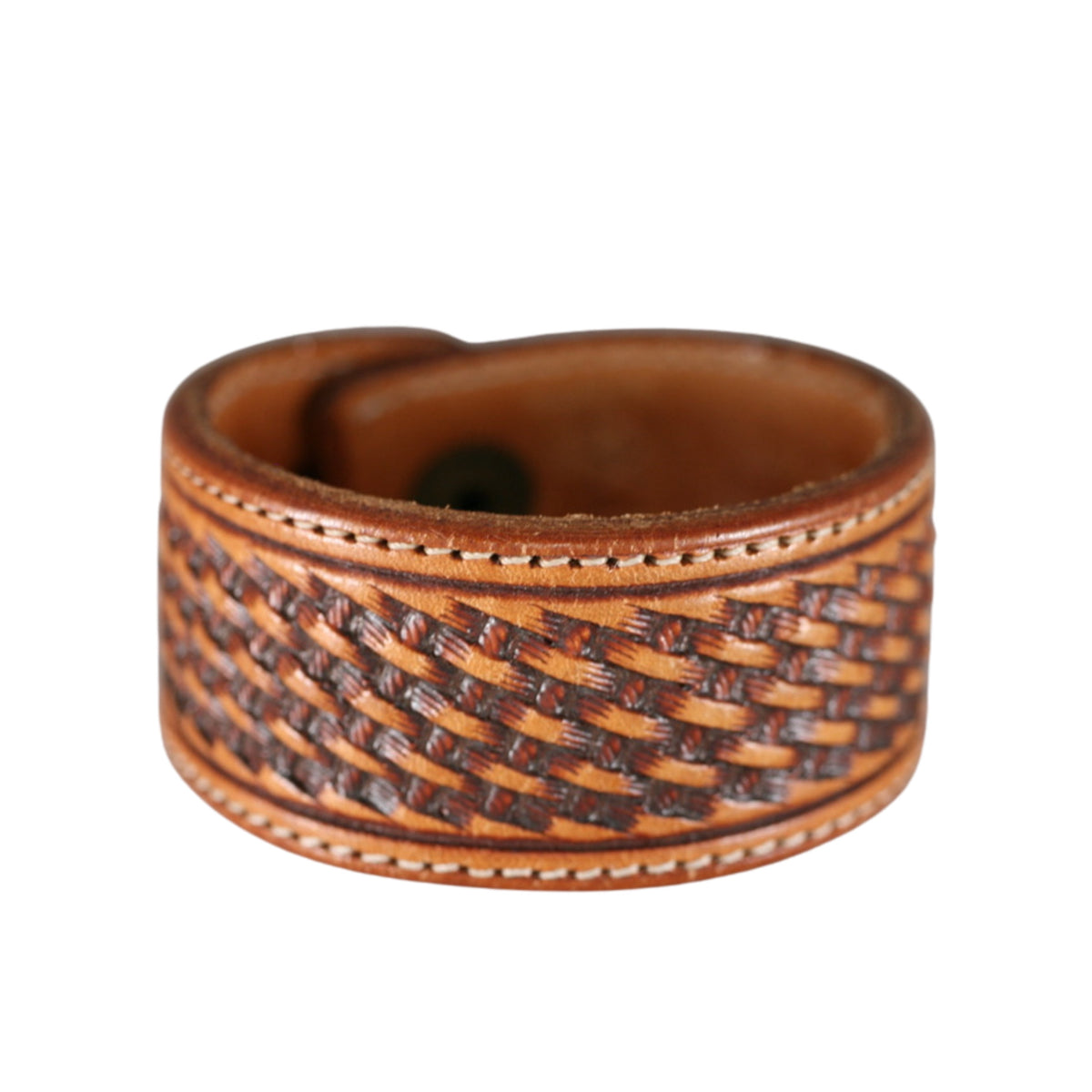 Handmade tan leather cuff bracelet featuring detailed basketweave tooling, decorative borders, and warm brown leather.