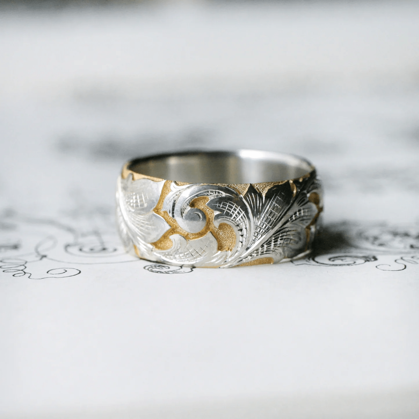 Two-tone wide acanthus band with hand-engraved scroll and leaf pattern – front view.