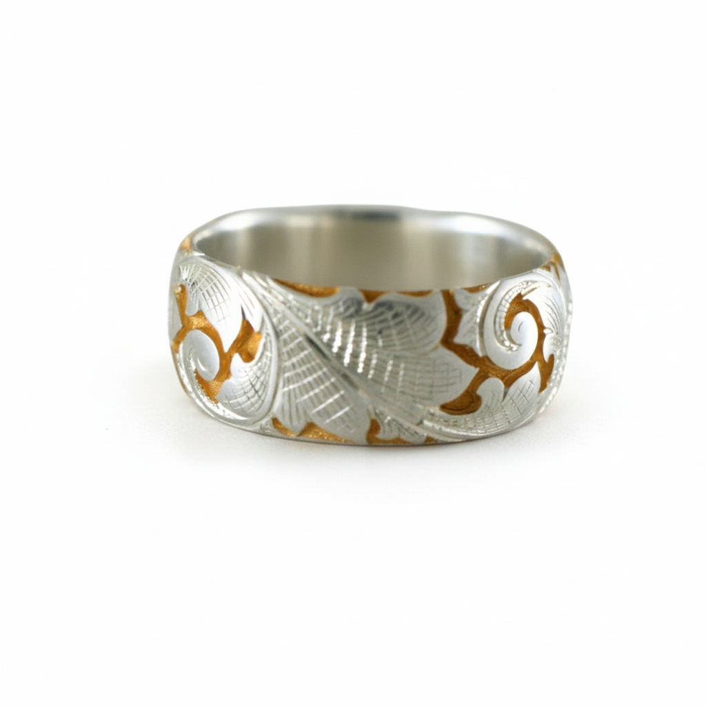 Wide two-tone acanthus engraved band in silver and gold on a white background.